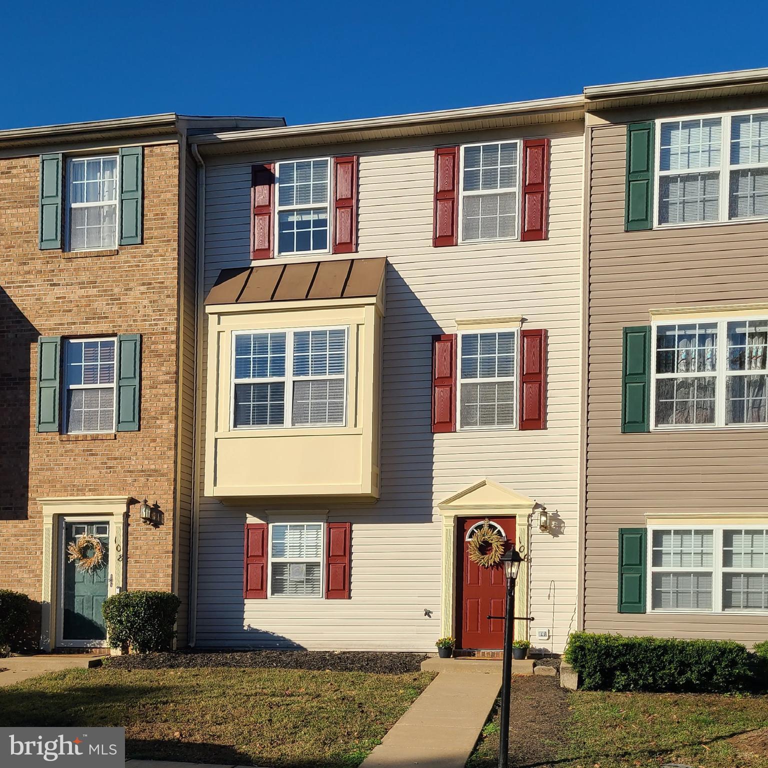 106 Regina Lane Fredericksburg, VA 22405 - Photo 1 of 31 a front view of a residential apartment building with a yard