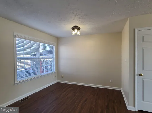 a kitchen with stainless steel appliances granite countertop a sink a stove a refrigerator cabinets and wooden floor