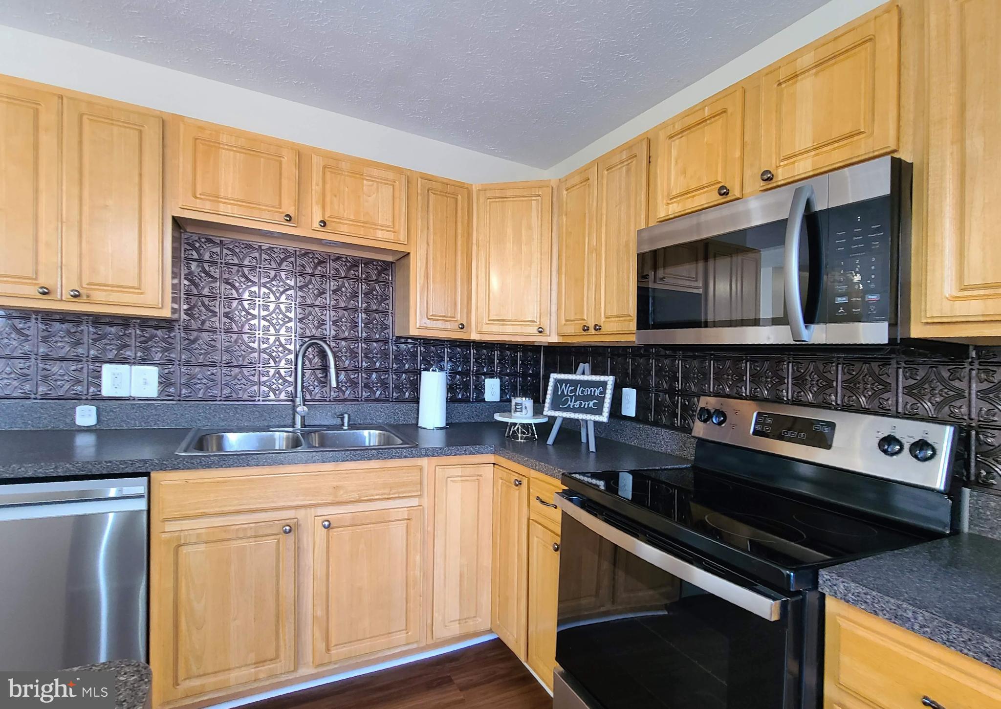 106 Regina Lane Fredericksburg, VA 22405 - Photo 16 of 31 a kitchen with stainless steel appliances granite countertop a sink stove and microwave