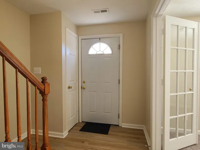 a view of entryway with wooden floor