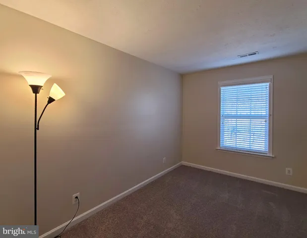 an empty room with closet area