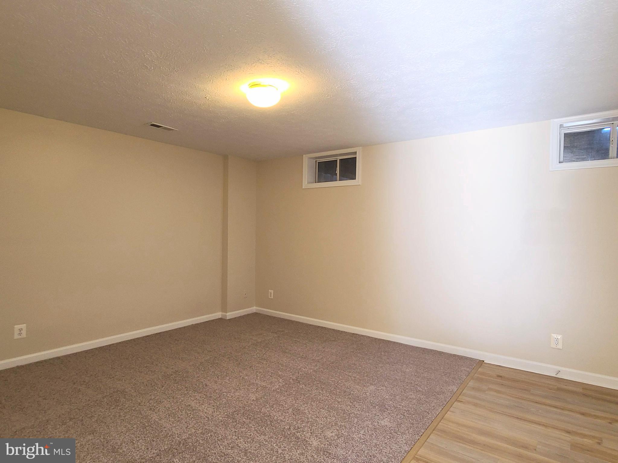 106 Regina Lane Fredericksburg, VA 22405 - Photo 8 of 31 an empty room with wooden floor and windows