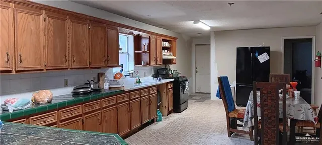 a kitchen with stainless steel appliances granite countertop a sink dishwasher cabinets and granite countertops with wooden floor