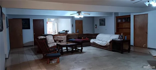 a living room with furniture a fireplace and a chandelier