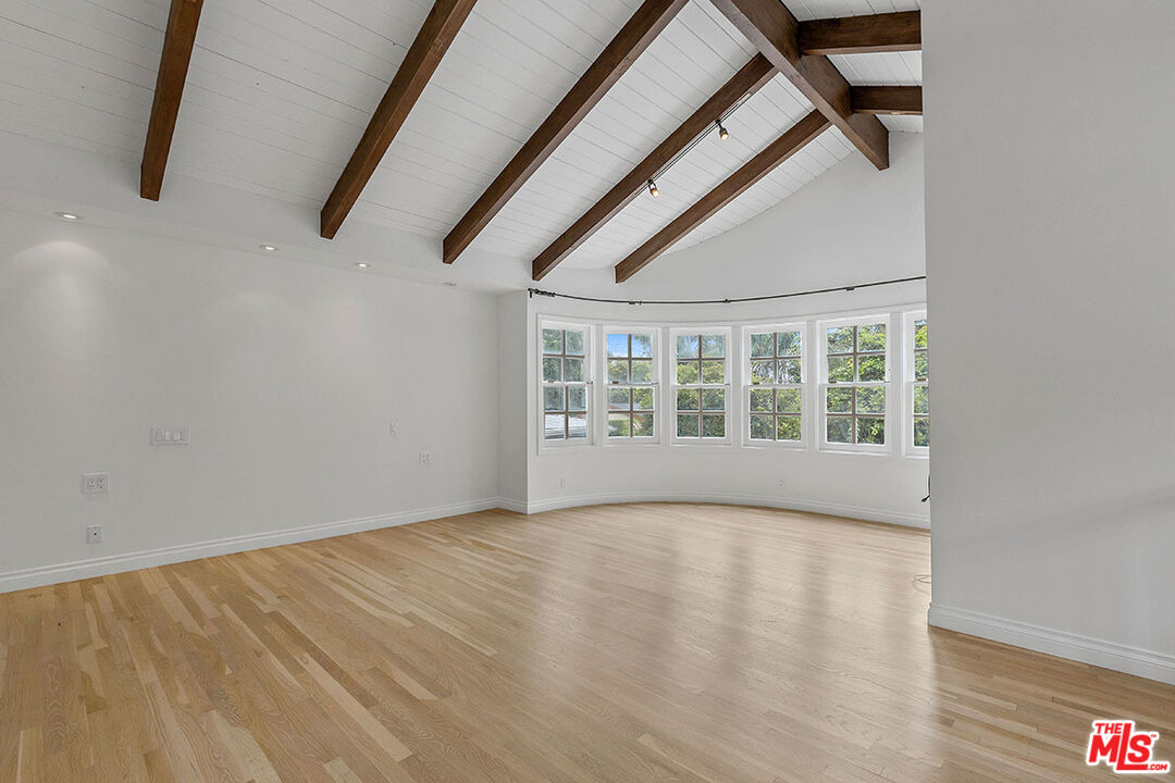 1462 Rising Glen Road Los Angeles, CA 90069 - Photo 23 of 39 a view of an empty room with a window and hardwood floor