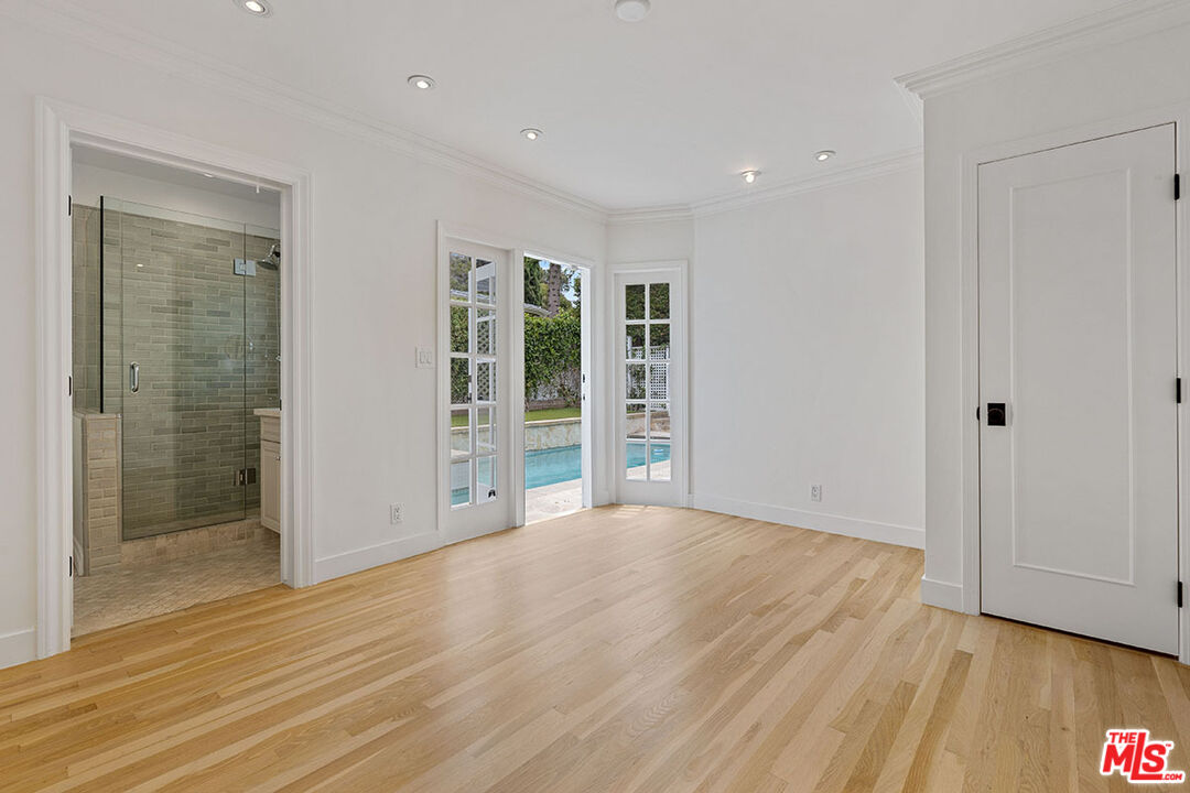 1462 Rising Glen Road Los Angeles, CA 90069 - Photo 33 of 39 a view of an empty room with wooden floor and a window