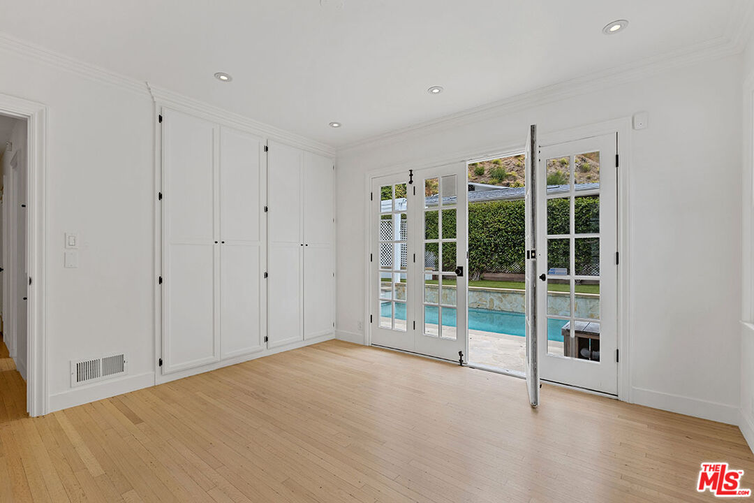 1462 Rising Glen Road Los Angeles, CA 90069 - Photo 34 of 39 a view of an empty room with glass door