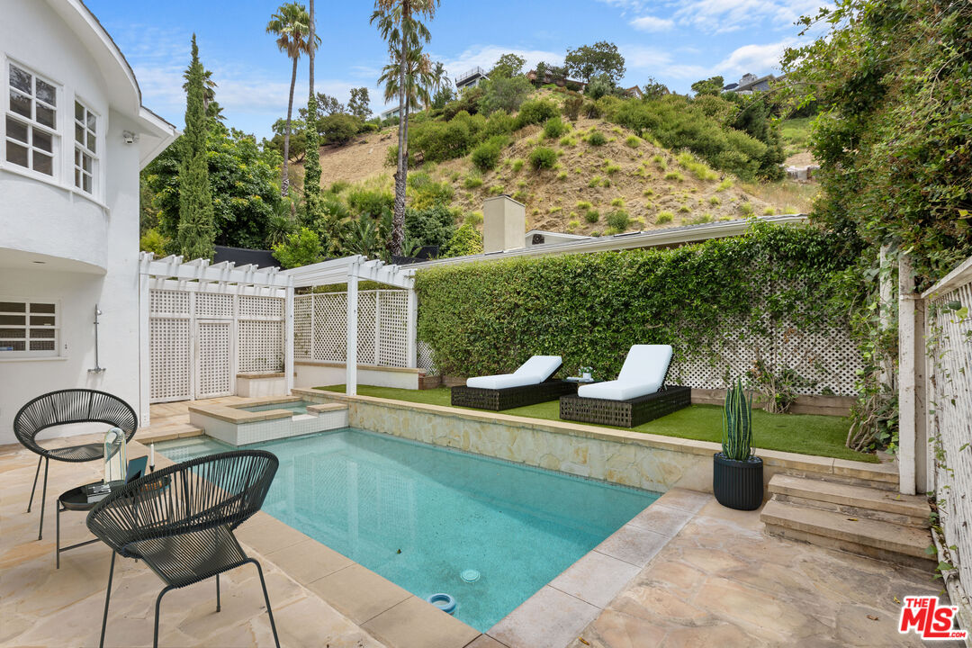 1462 Rising Glen Road Los Angeles, CA 90069 - Photo 38 of 39 a white bench sitting in the backyard of a house