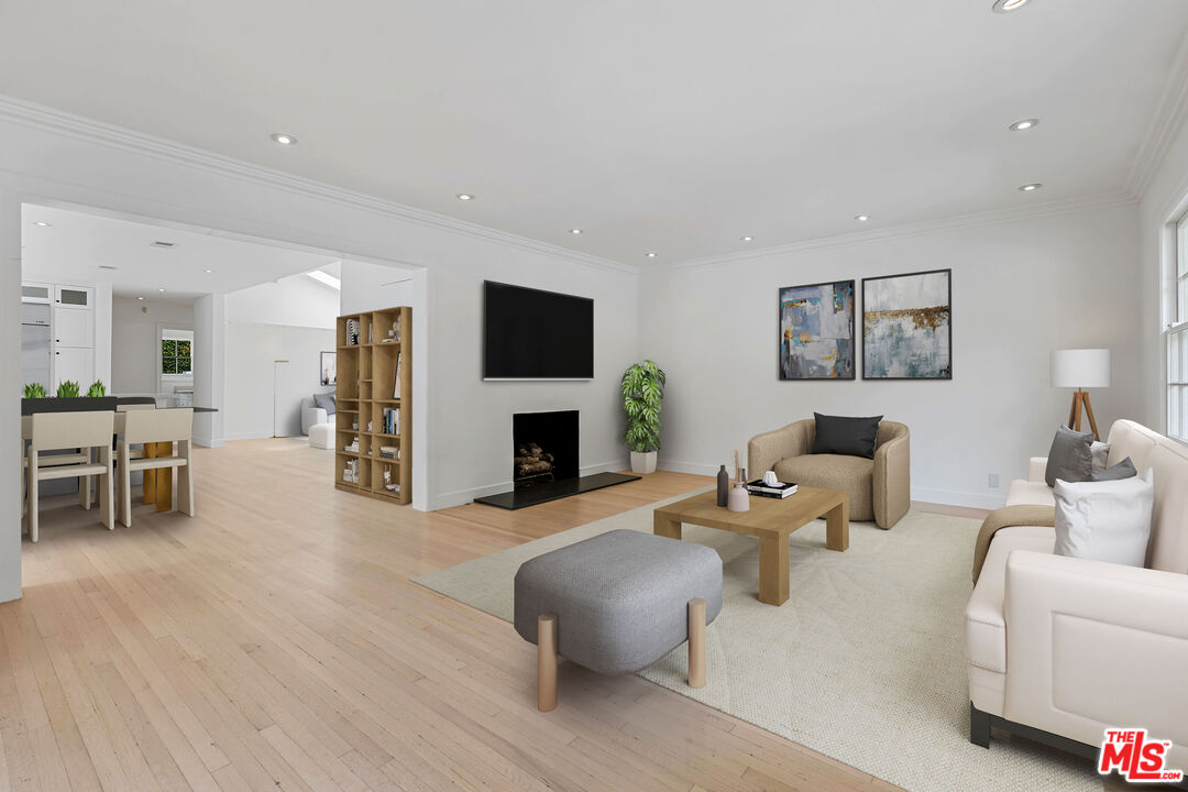 1462 Rising Glen Road Los Angeles, CA 90069 - Photo 9 of 39 a living room with furniture a fireplace and a flat screen tv