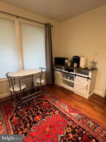 a living room with a couch and a rug