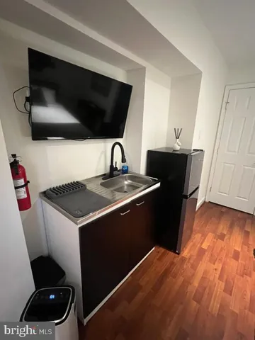 a kitchen with a sink and a stove top oven