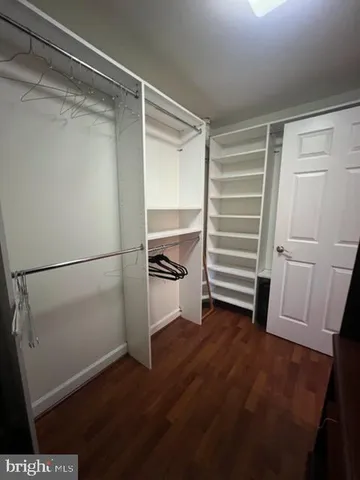 a view of walk in closet with empty racks