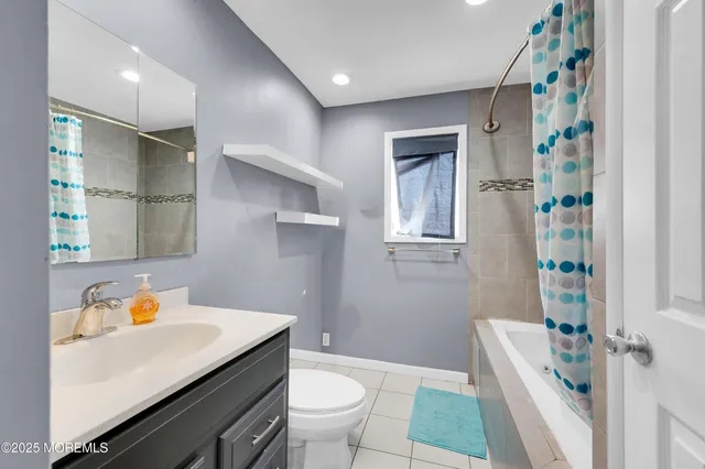 a bathroom with a sink toilet vanity and bathtub