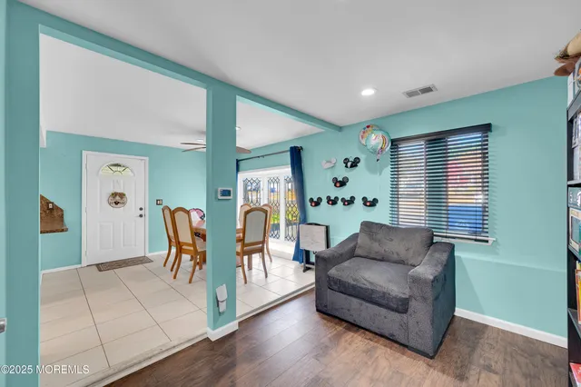 a living room with furniture and wooden floor