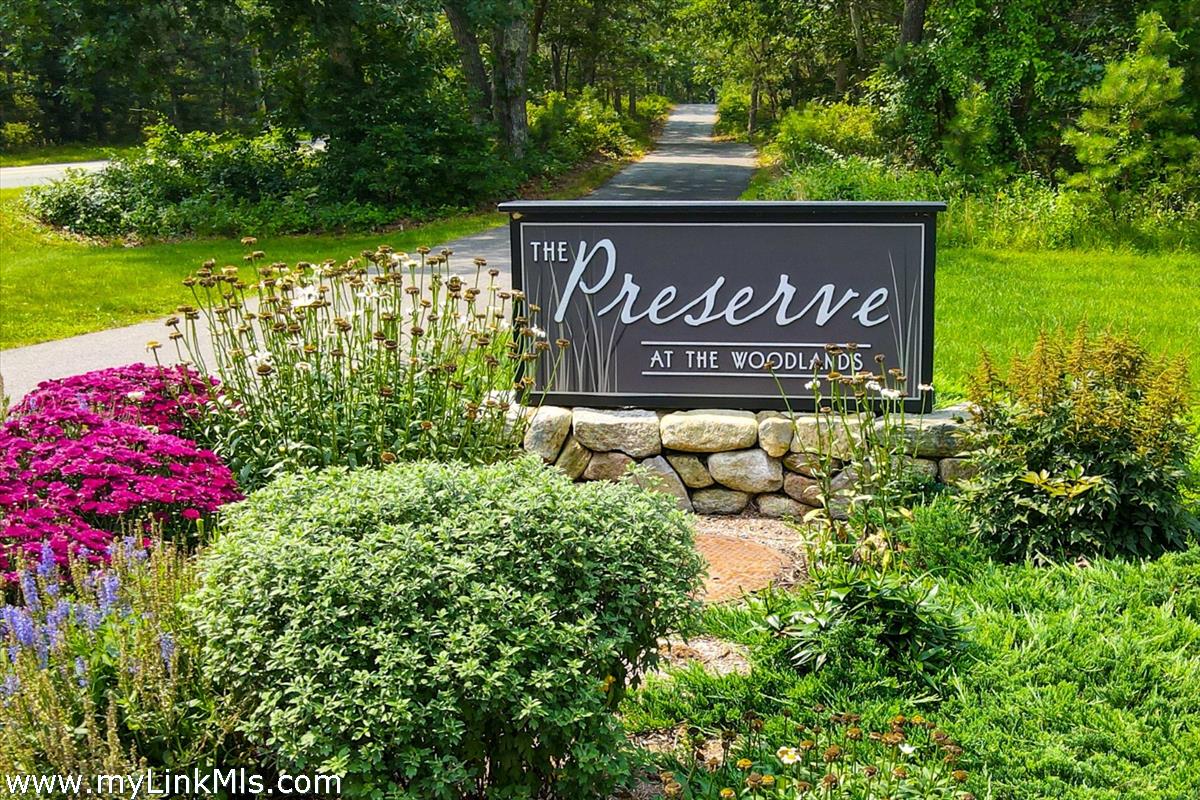 22 Paddock Road Oak Bluffs, MA 02557 - Photo 2 of 6 a sign that is sitting in front of flowers