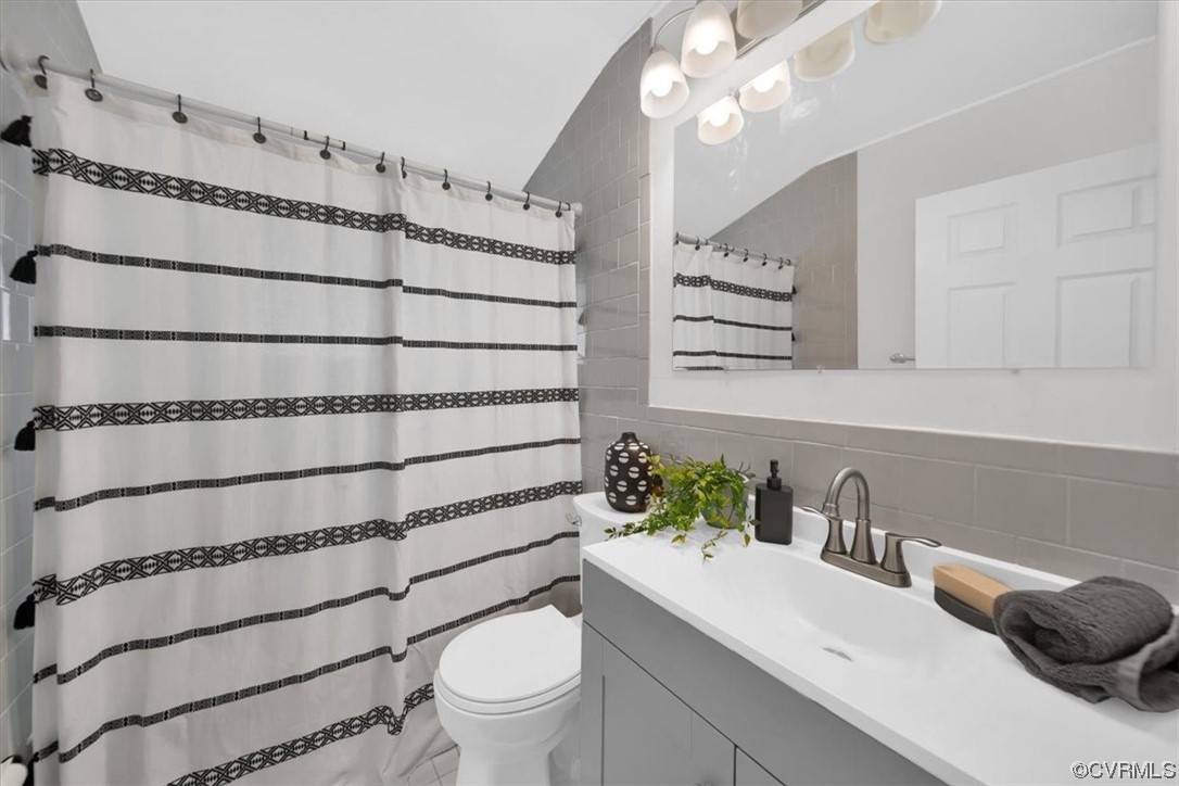 9419 Camrose Road Henrico, VA 23229 - Photo 22 of 29 a bathroom with a sink a toilet and a mirror