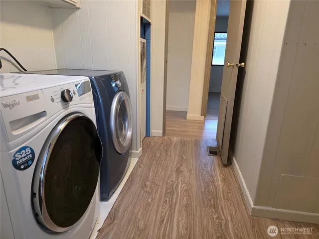 a view of a storage and utility room with washer and dryer