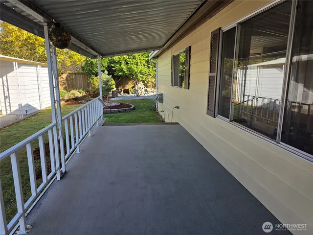 a view of a porch with wooden floor and outdoor space