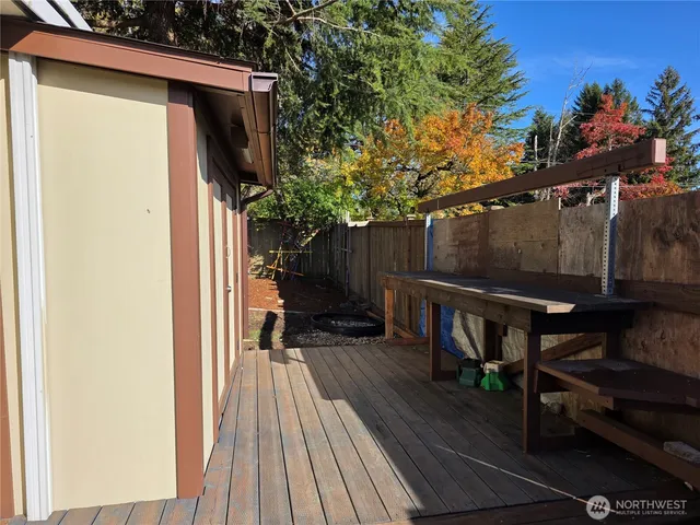 a view of balcony with wooden floor and outdoor seating