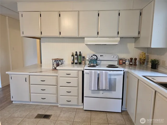 a kitchen with cabinets appliances and a sink