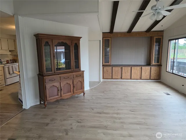 a view of a hallway and a livingroom with a couch