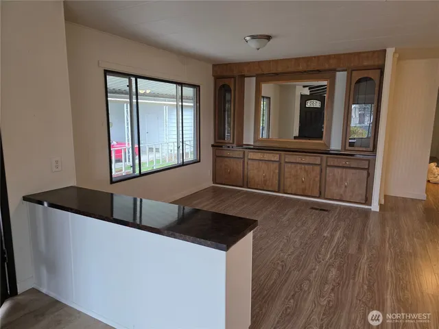 a kitchen with granite countertop a sink and wooden cabinets