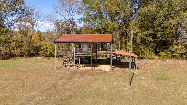 a view of a patio with a table and chairs under an umbrella