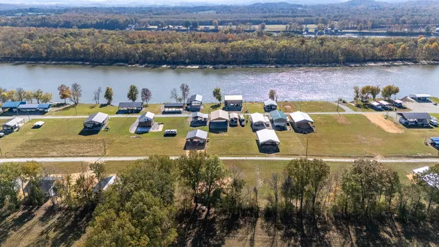 an aerial view of a house with a lake view