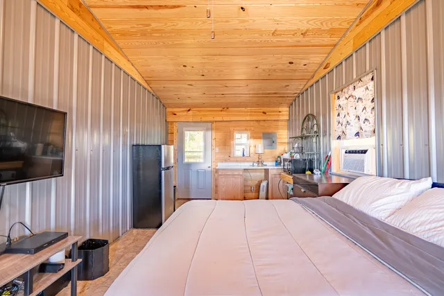 a bed room with a bed and a large window