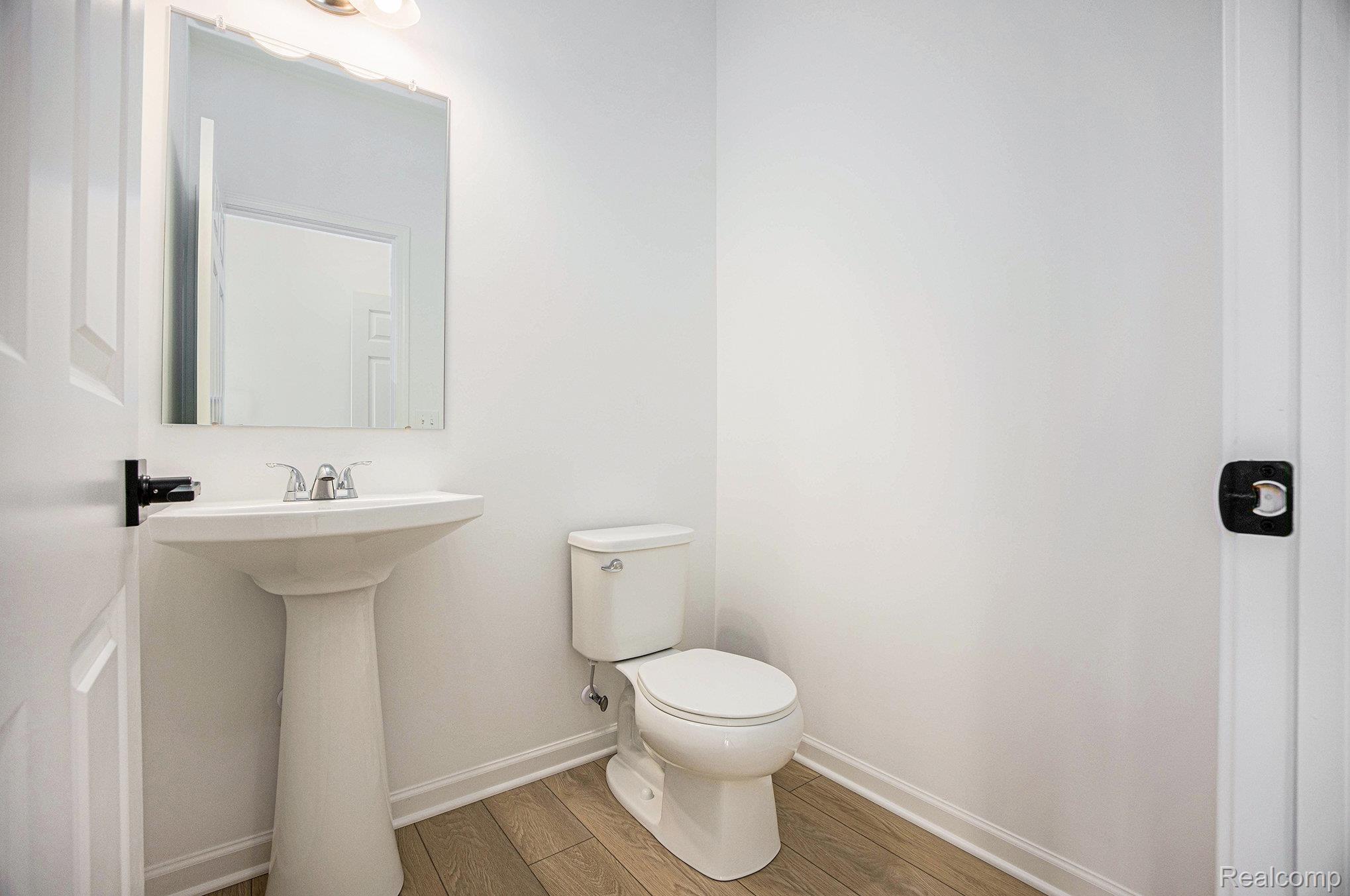 68788 Place Road New Haven, MI 48050 - Photo 24 of 29 Half bathroom featuring wood finished floors and baseboards