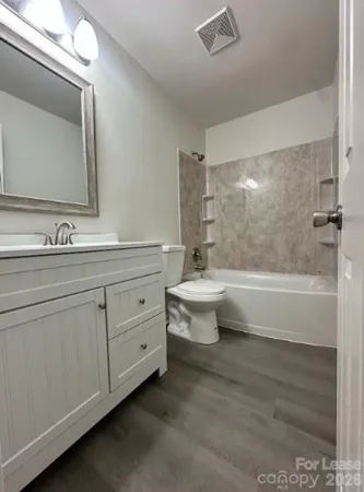 a bathroom with a double vanity sink a toilet and a mirror