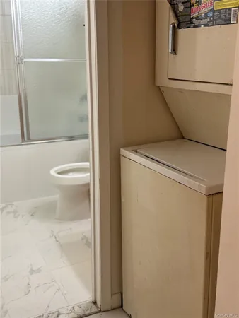 a bathroom with a toilet and a shower