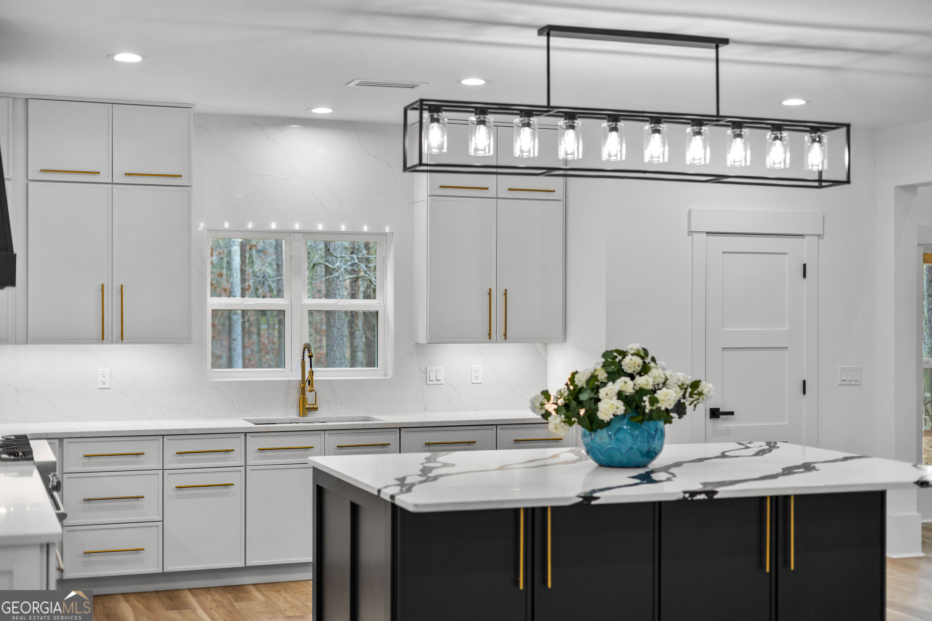 354 Turner Road Newnan, GA 30263 - Photo 19 of 83 a kitchen with cabinets stainless steel appliances and a chandelier