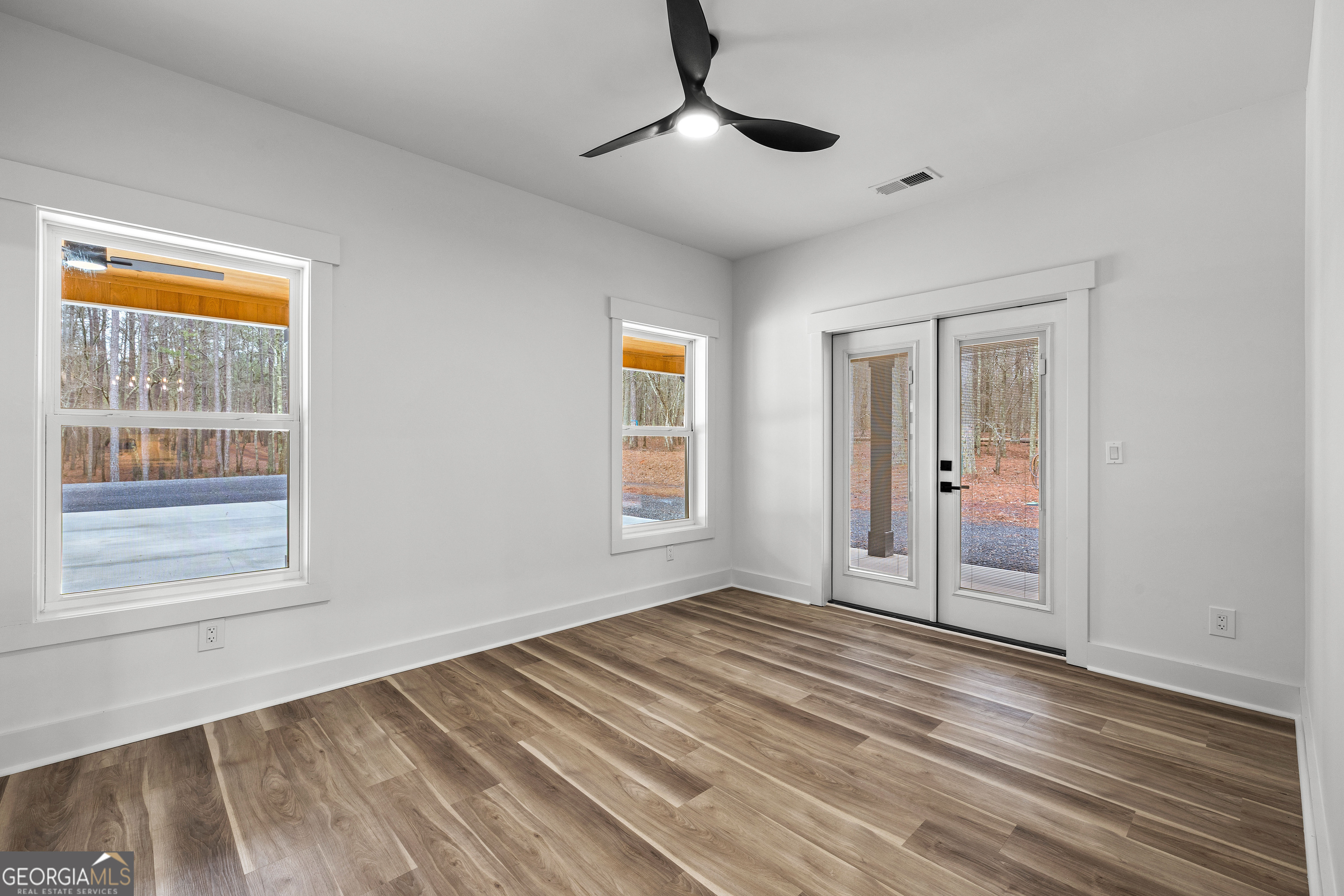 354 Turner Road Newnan, GA 30263 - Photo 31 of 83 a view of an empty room with wooden floor and a window