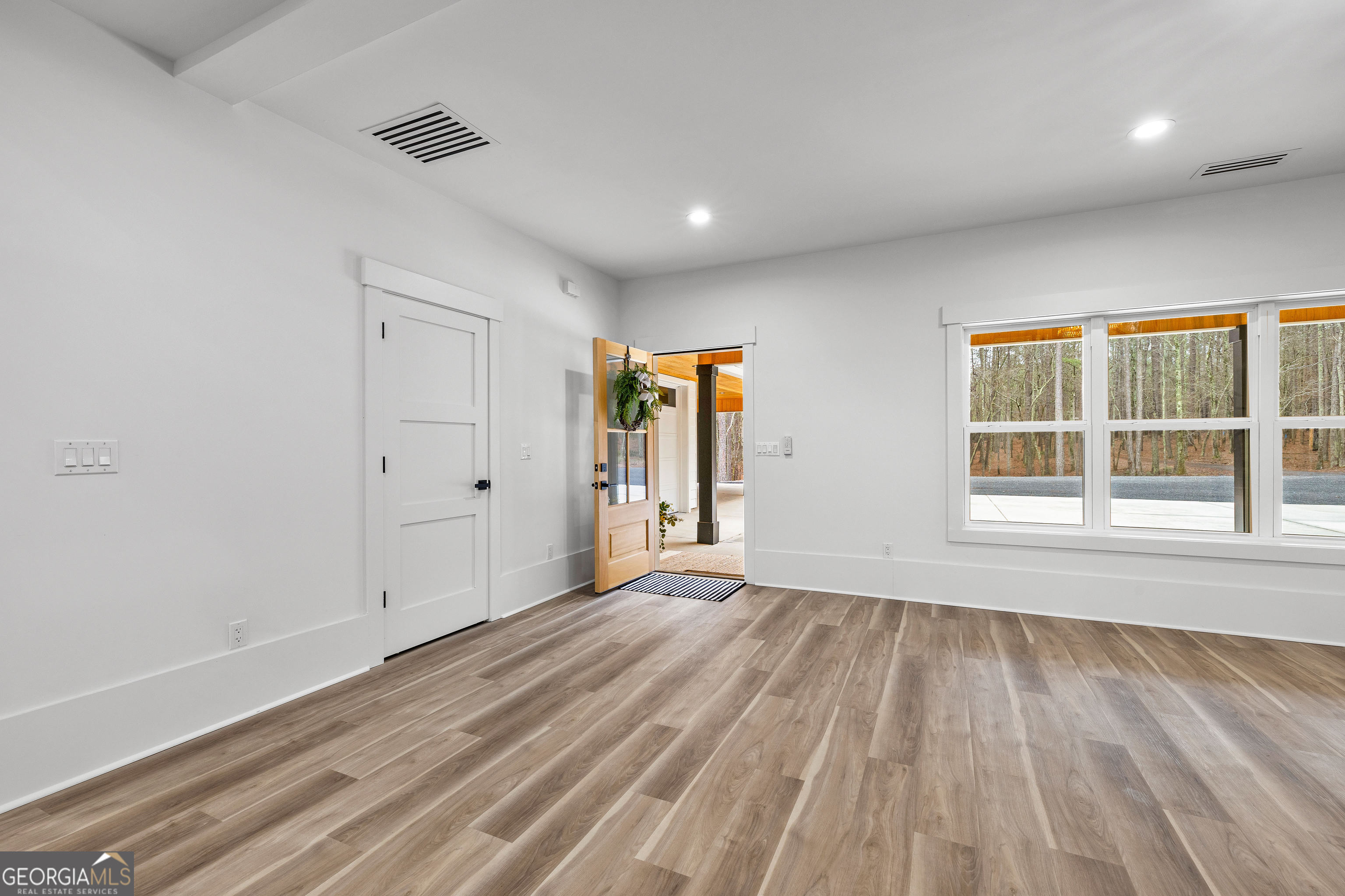 354 Turner Road Newnan, GA 30263 - Photo 41 of 83 a view of an empty room with wooden floor and a window