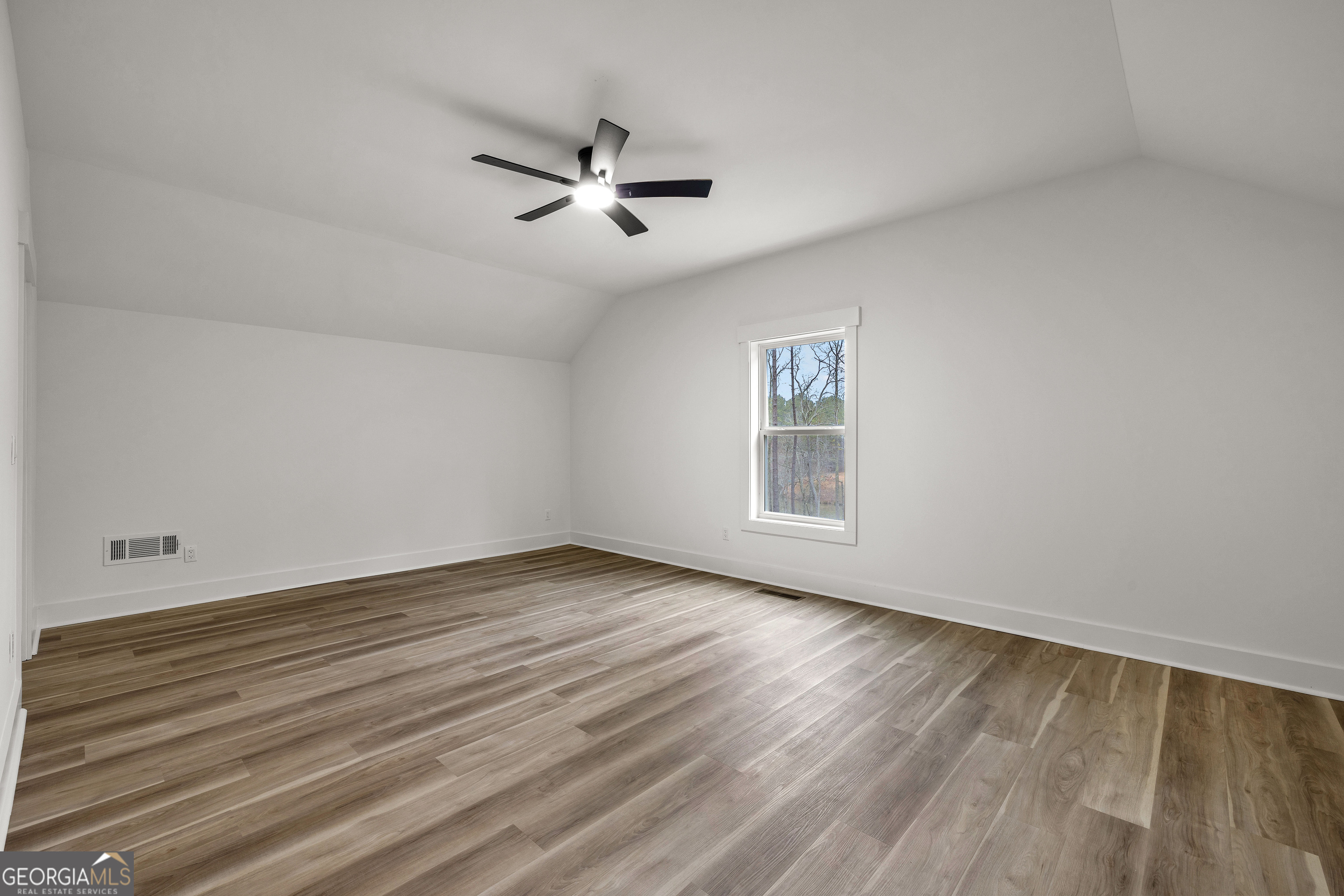 354 Turner Road Newnan, GA 30263 - Photo 50 of 83 a view of an empty room with wooden floor and a window