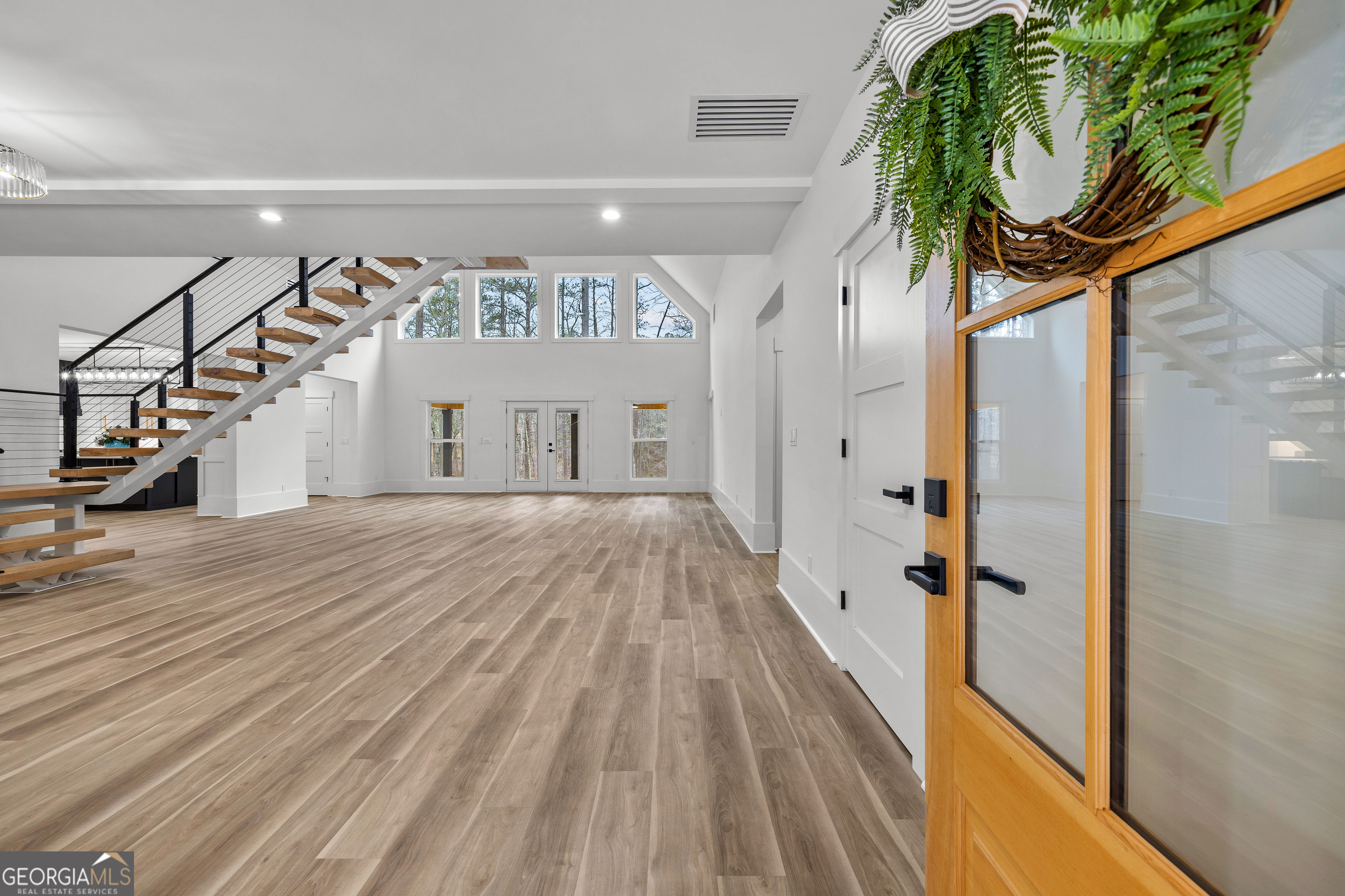 354 Turner Road Newnan, GA 30263 - Photo 5 of 83 a view of a hallway with a white walls and stairs