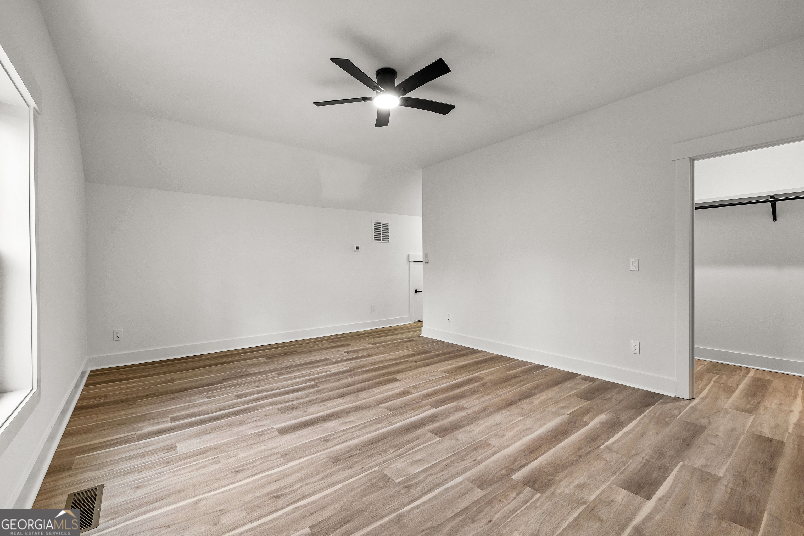 354 Turner Road Newnan, GA 30263 - Photo 56 of 83 an empty room with wooden floor and a ceiling fan