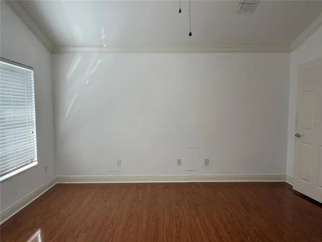 an empty room with wooden floor