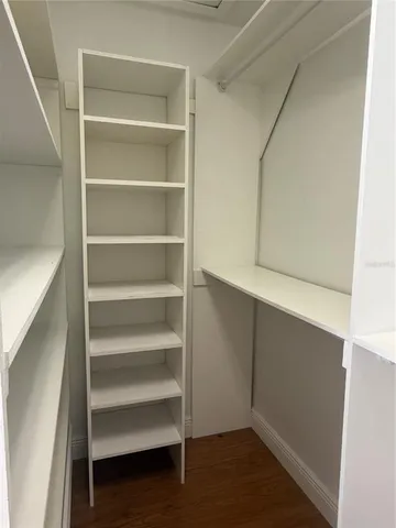 a view of walk in closet with empty racks