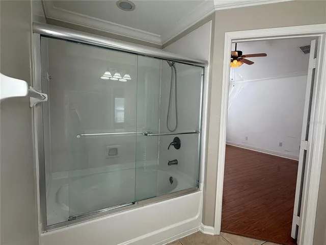 a bathroom with a glass shower door