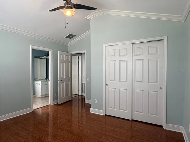 a view of empty room with wooden floor