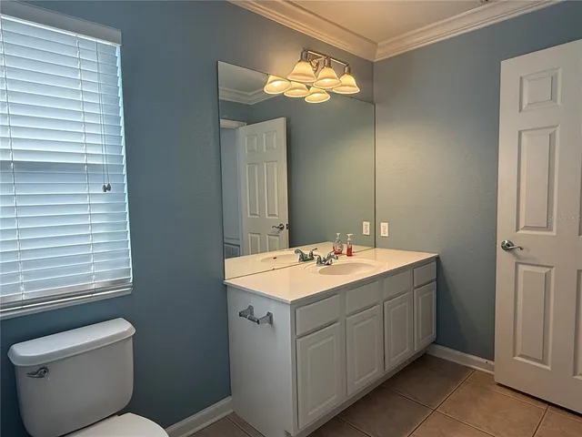 a view of bathroom with a toilet sink and mirror