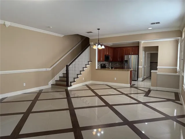 a view of a livingroom with furniture and an entryway