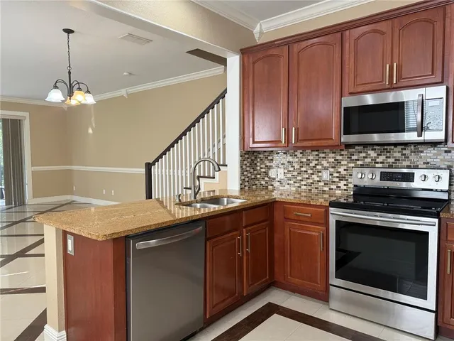 a kitchen with a sink stove and microwave