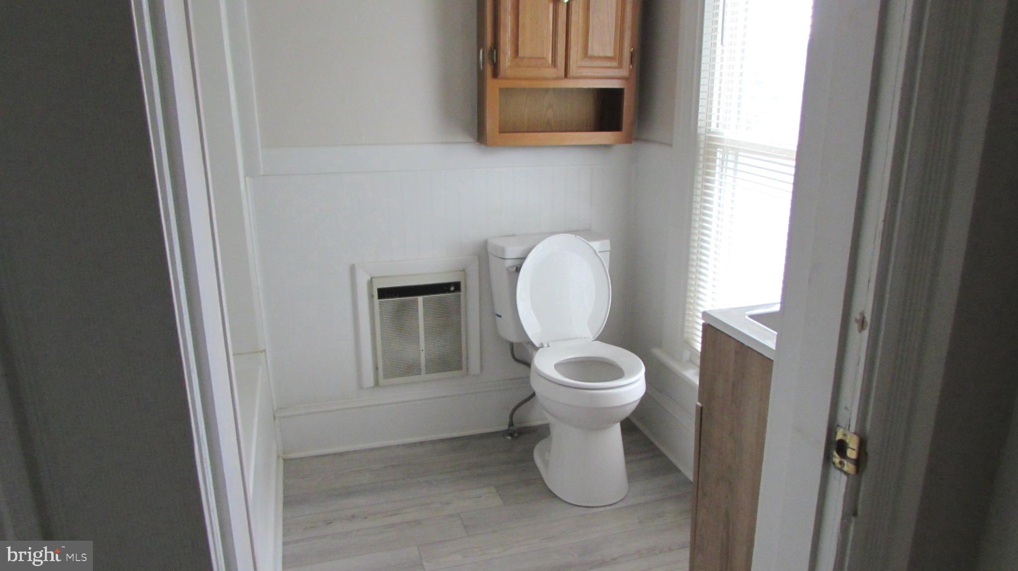 207 Gay Street Denton, MD 21629 - Photo 9 of 25 a white toilet sitting next to a bathroom sink