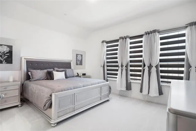 a bedroom with a bed and a television