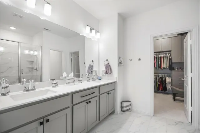 a bathroom with a double vanity sink and a mirror