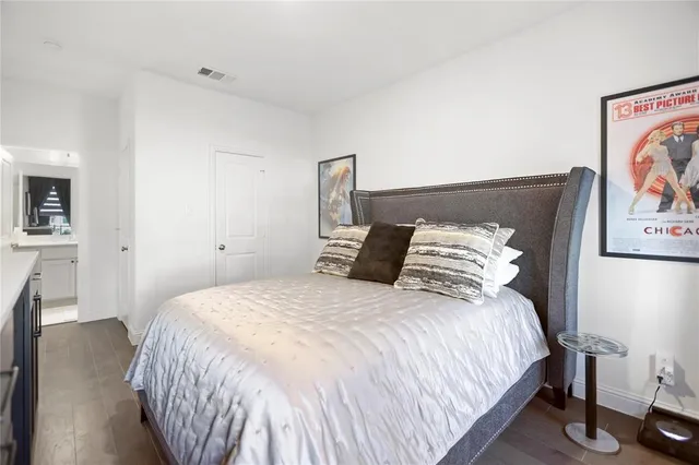 a bedroom with a bed and painting on the wall