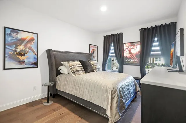 a bedroom with a large bed and a large window